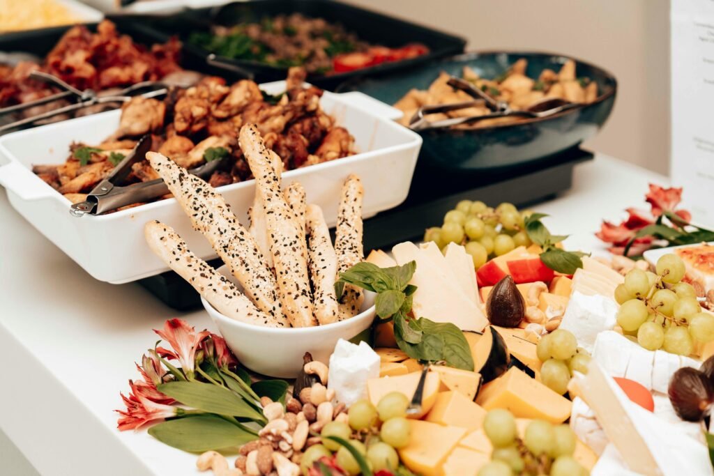 pexels-photo-29086309-29086309 A mouth-watering assortment of cheeses, breadsticks, and fruits in a buffet setting. Perfect for catering events.