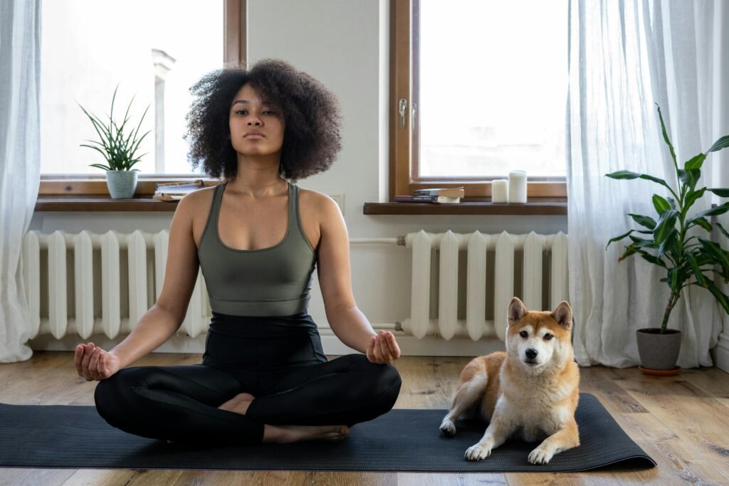 pexels-photo-4056535-4056535 A woman practices yoga at home with her Shiba Inu dog, embracing a relaxing morning.