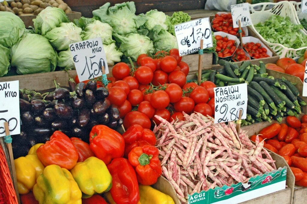 pexels-photo-11097810-11097810 Colorful variety of fresh vegetables displayed at an outdoor market stall with price signs.