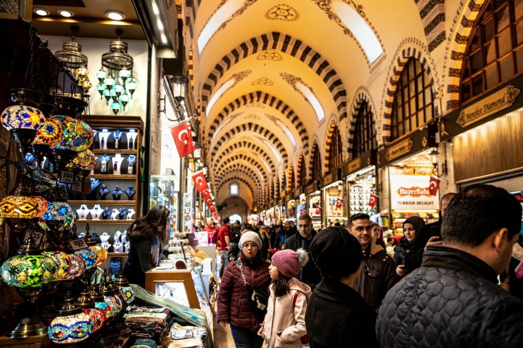 pexels-photo-3619724-3619724 Colorful lamps and bustling crowd in Istanbul's historic Grand Bazaar, rich in culture and commerce.