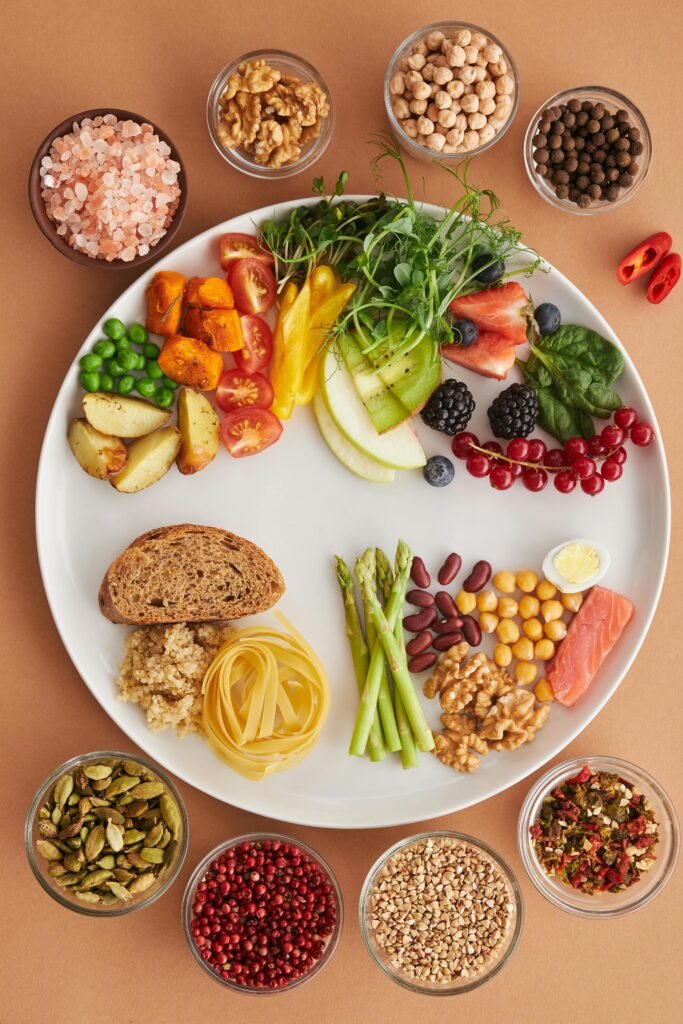 pexels-photo-5966434-5966434 A vibrant assortment of healthy foods on a plate, showcasing a balanced diet with fruits, vegetables, nuts, and grains.